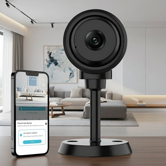 Black security camera on a stand with a smartphone displaying an app interface.